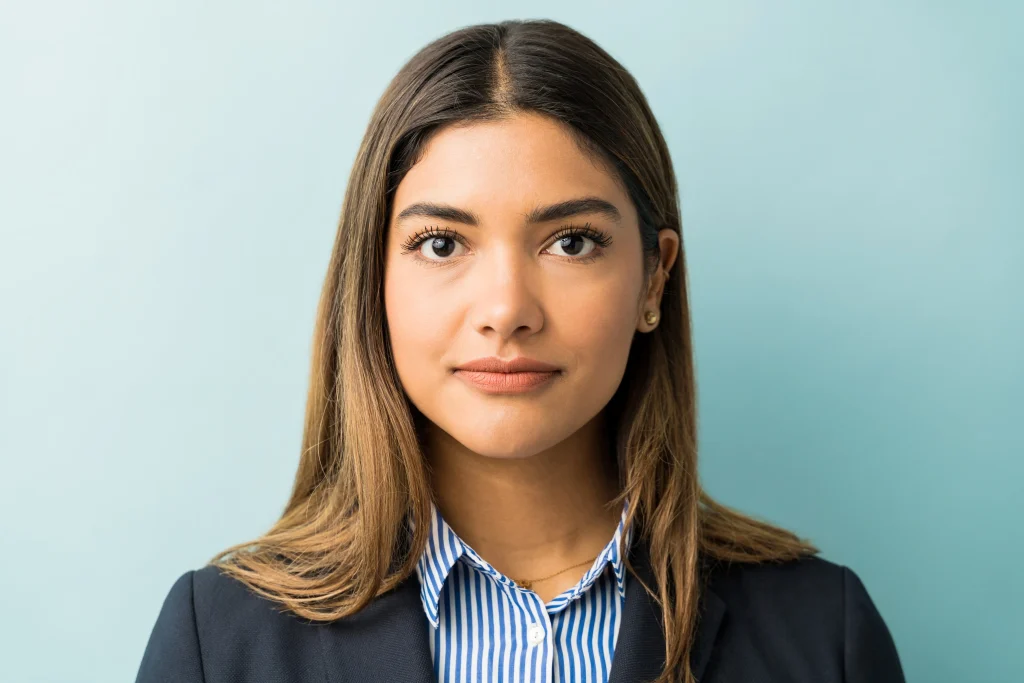Closeup young female professional making eye contact against colored background result 1024x683